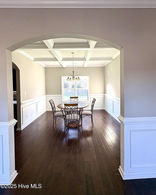 dining area featuring beam ceiling, an inviting chandelier, coffered ceiling, and ornamental molding