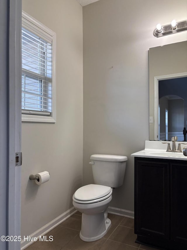 bathroom featuring tile patterned floors, vanity, and toilet