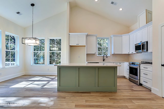 3375 Sandridge Ln SW, Supply, NC 28462 - kitchen with visible vents, high vaulted ceiling, white cabinetry, and appliances with stainless steel finishes