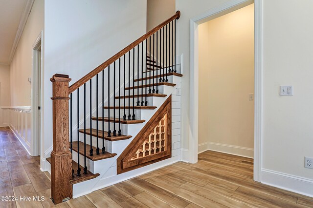 staircase featuring crown molding