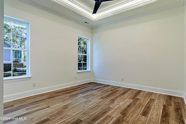 empty room with ceiling fan, ornamental molding, and light hardwood / wood-style flooring