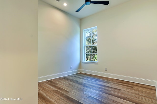 unfurnished room with baseboards, dark wood finished floors, a ceiling fan, and recessed lighting