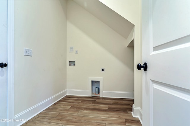 clothes washing area with laundry area, baseboards, wood finished floors, hookup for an electric dryer, and washer hookup