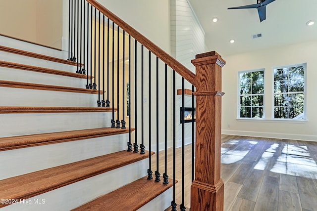 staircase with baseboards, visible vents, ceiling fan, wood finished floors, and recessed lighting