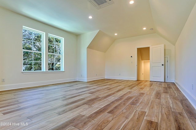 bonus room featuring light wood finished floors, recessed lighting, lofted ceiling, visible vents, and baseboards