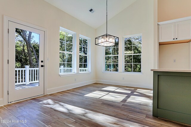 bonus room featuring light wood-type flooring and vaulted ceiling