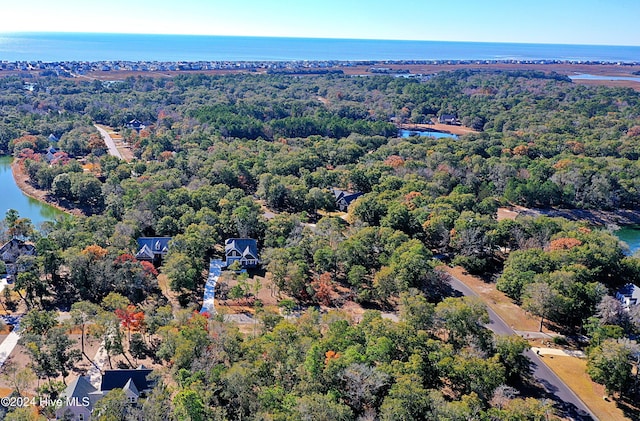 aerial view featuring a water view and a forest view