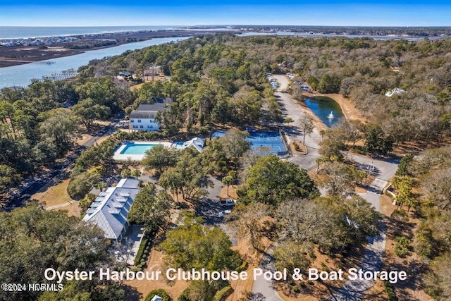 drone / aerial view with a water view and a wooded view