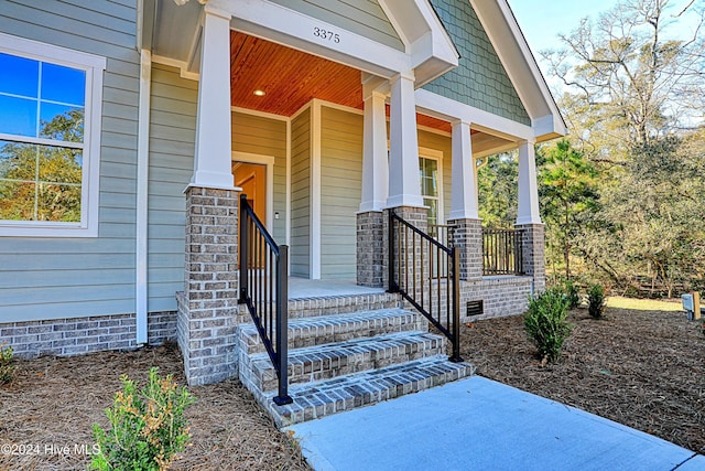 doorway to property featuring covered porch