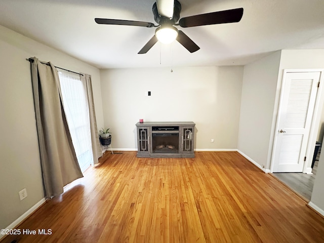 unfurnished living room with a fireplace, light hardwood / wood-style flooring, and ceiling fan