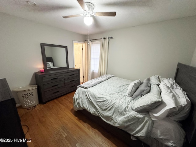 bedroom featuring hardwood / wood-style floors and ceiling fan