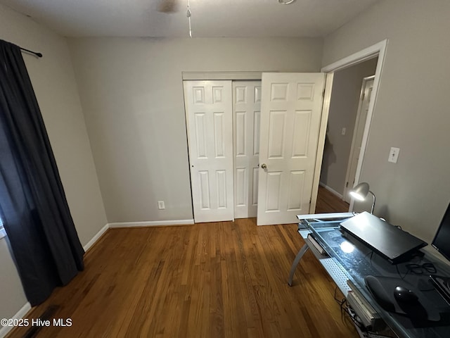 unfurnished bedroom with hardwood / wood-style flooring and a closet