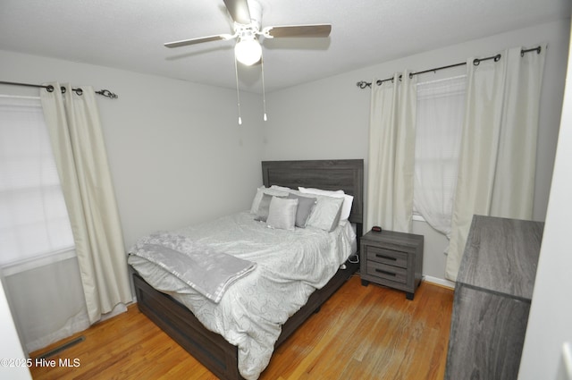 bedroom featuring hardwood / wood-style floors and ceiling fan