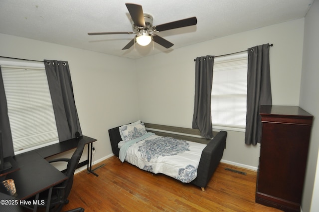 bedroom featuring ceiling fan and dark wood-type flooring