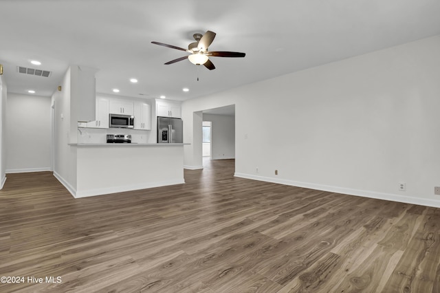 unfurnished living room with ceiling fan and wood-type flooring