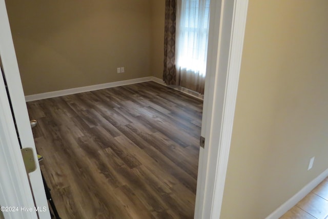 unfurnished room with hardwood / wood-style floors