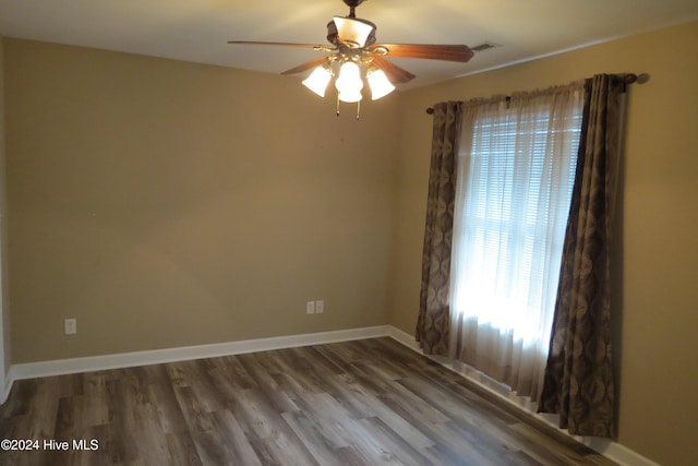 spare room featuring hardwood / wood-style floors and ceiling fan