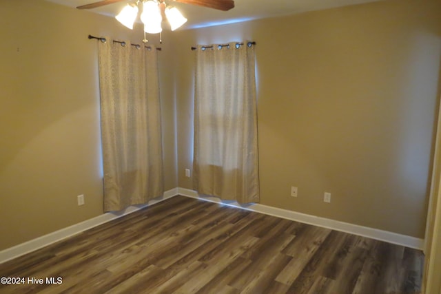 spare room featuring ceiling fan and dark hardwood / wood-style flooring