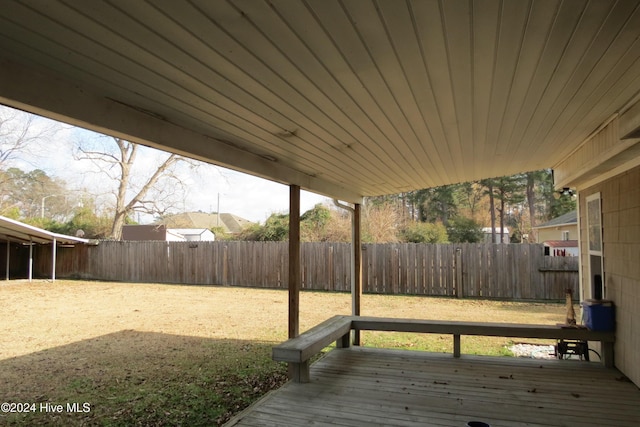 wooden terrace featuring a lawn