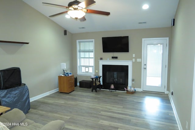 living room with vaulted ceiling, light hardwood / wood-style flooring, a wealth of natural light, and ceiling fan