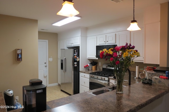 kitchen with white cabinetry, sink, hanging light fixtures, stainless steel appliances, and kitchen peninsula