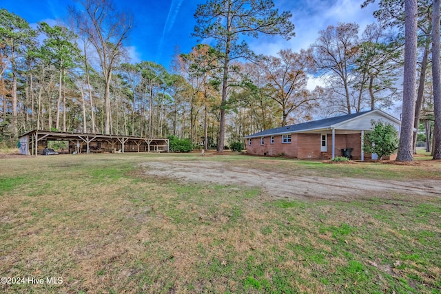 view of side of property featuring a lawn and central AC