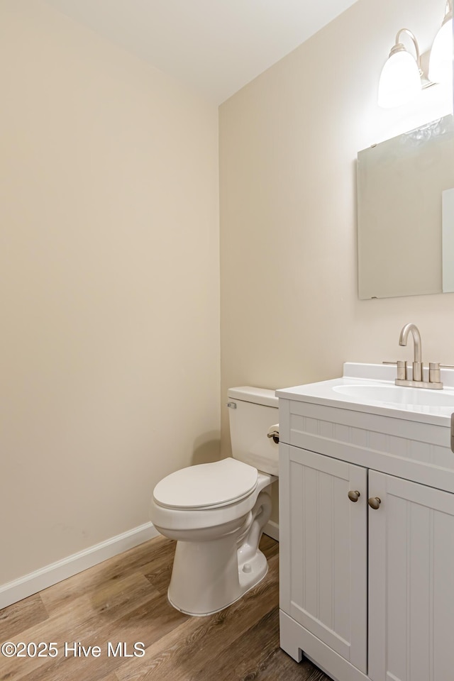 bathroom featuring hardwood / wood-style flooring, vanity, and toilet