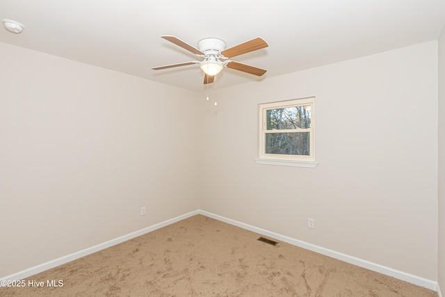 carpeted spare room with ceiling fan