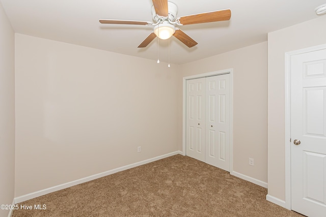 unfurnished bedroom with light carpet, a closet, and ceiling fan