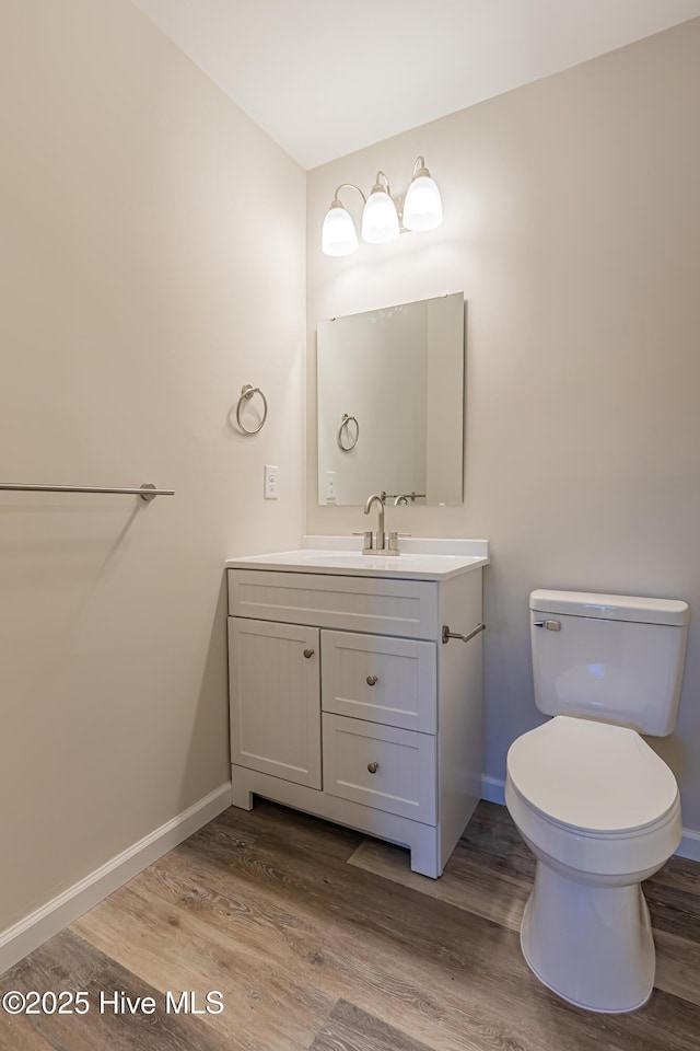 bathroom featuring vanity, toilet, and wood-type flooring