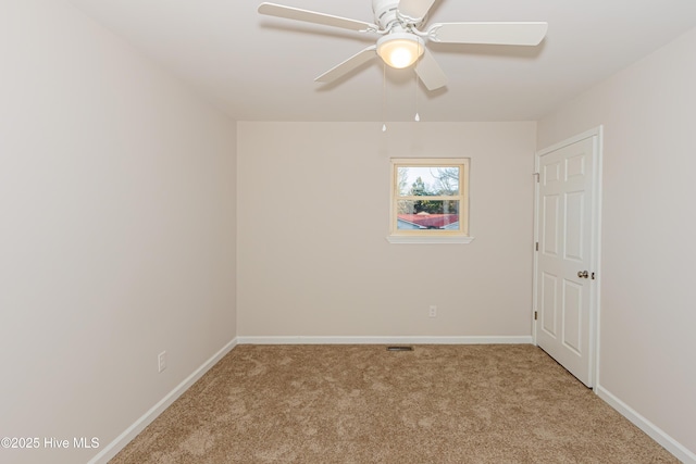 empty room featuring light carpet and ceiling fan