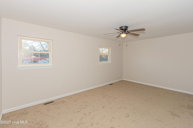 empty room featuring carpet flooring and ceiling fan