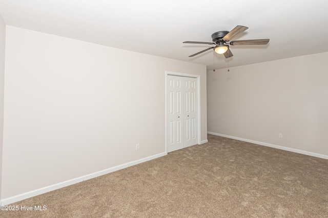 empty room featuring carpet flooring and ceiling fan