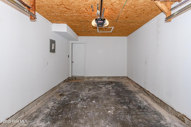 garage with electric panel and a garage door opener