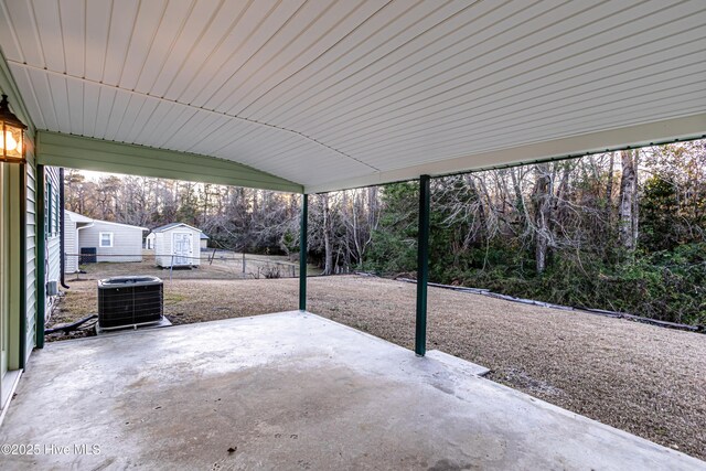 view of patio featuring a storage unit and central AC unit