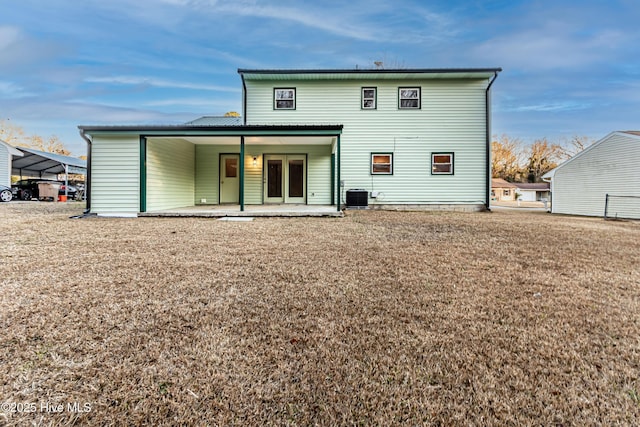 back of property with central AC and a patio area