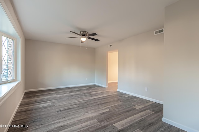 spare room featuring dark hardwood / wood-style floors and ceiling fan