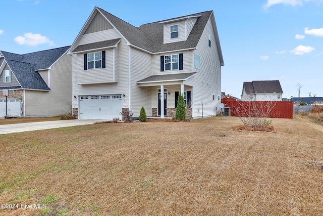 view of front of property featuring a garage and a front lawn