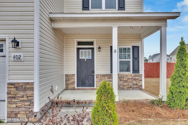 doorway to property featuring a porch