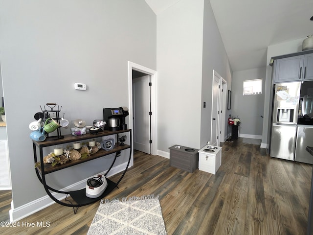 hall with dark hardwood / wood-style flooring and lofted ceiling