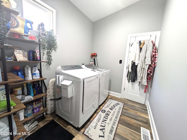 laundry area with hardwood / wood-style floors and independent washer and dryer