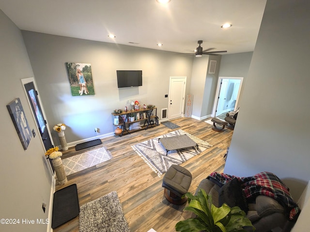 living room featuring ceiling fan and wood-type flooring