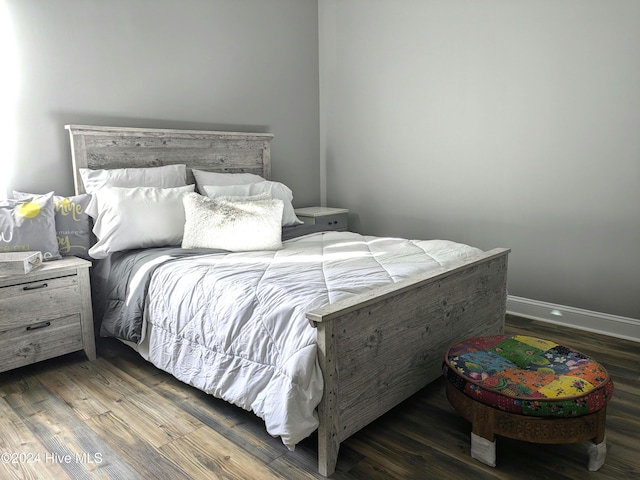 bedroom with dark hardwood / wood-style flooring