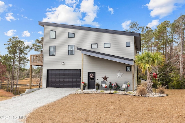 rear view of house with a garage