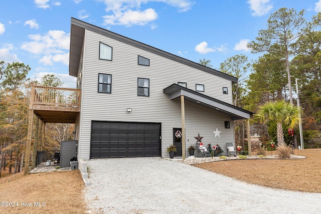 view of front of property featuring a deck and a garage