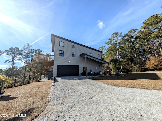 view of front of home featuring a deck and a garage