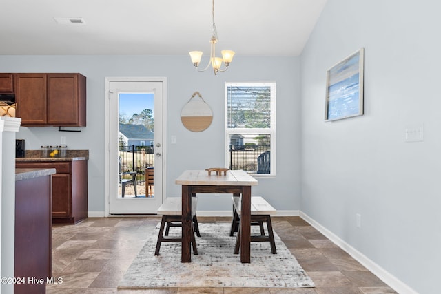 dining space with a wealth of natural light, visible vents, baseboards, and a chandelier