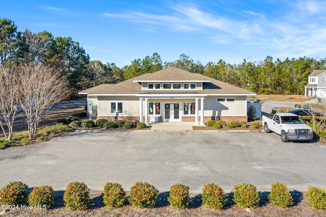 view of front of home with french doors and brick siding