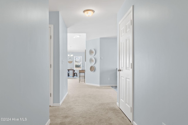 corridor with baseboards and carpet