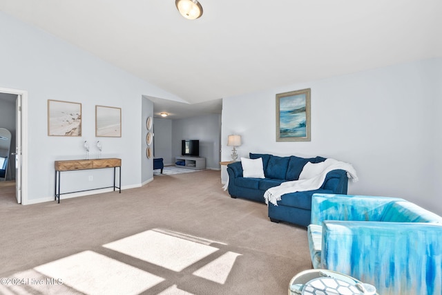 living area featuring baseboards, carpet, and vaulted ceiling